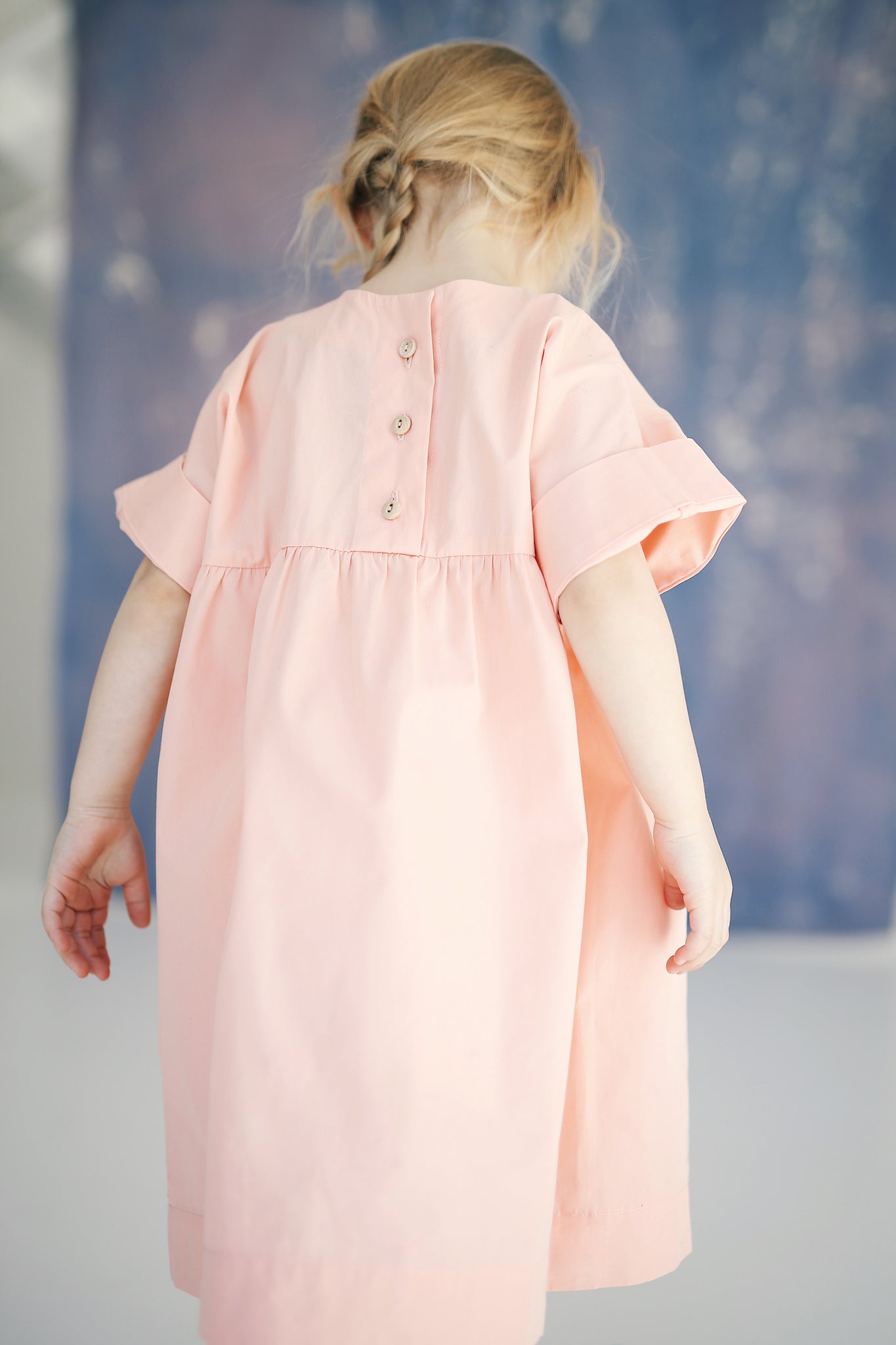 pink dress with buttons on the back