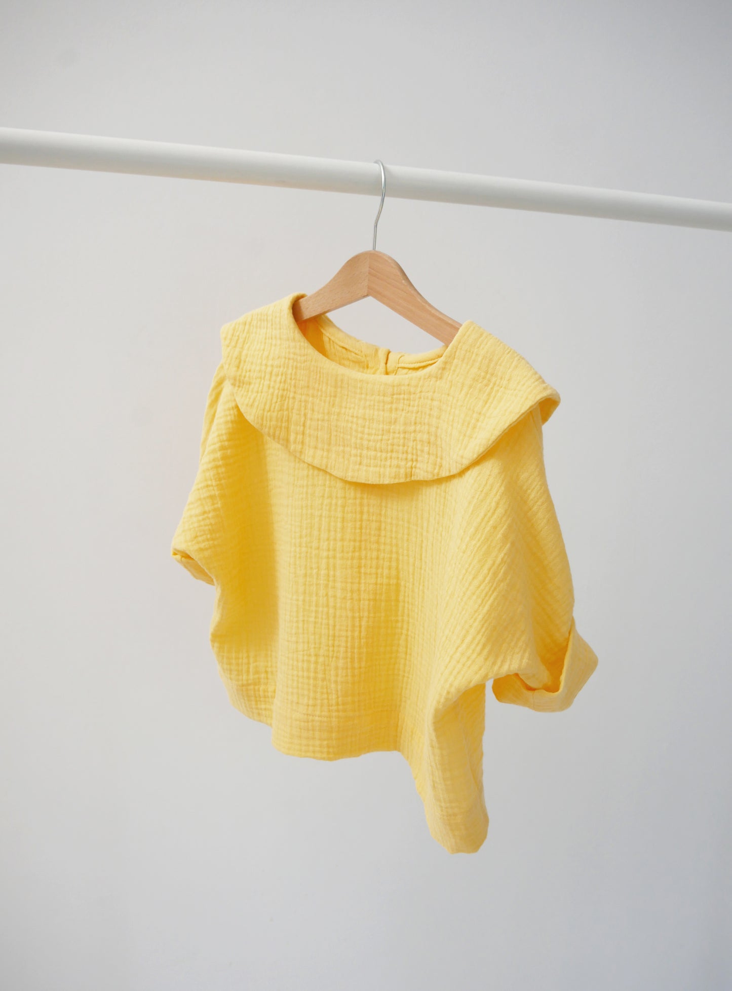 yellow shirt with big, round collar with short sleeves