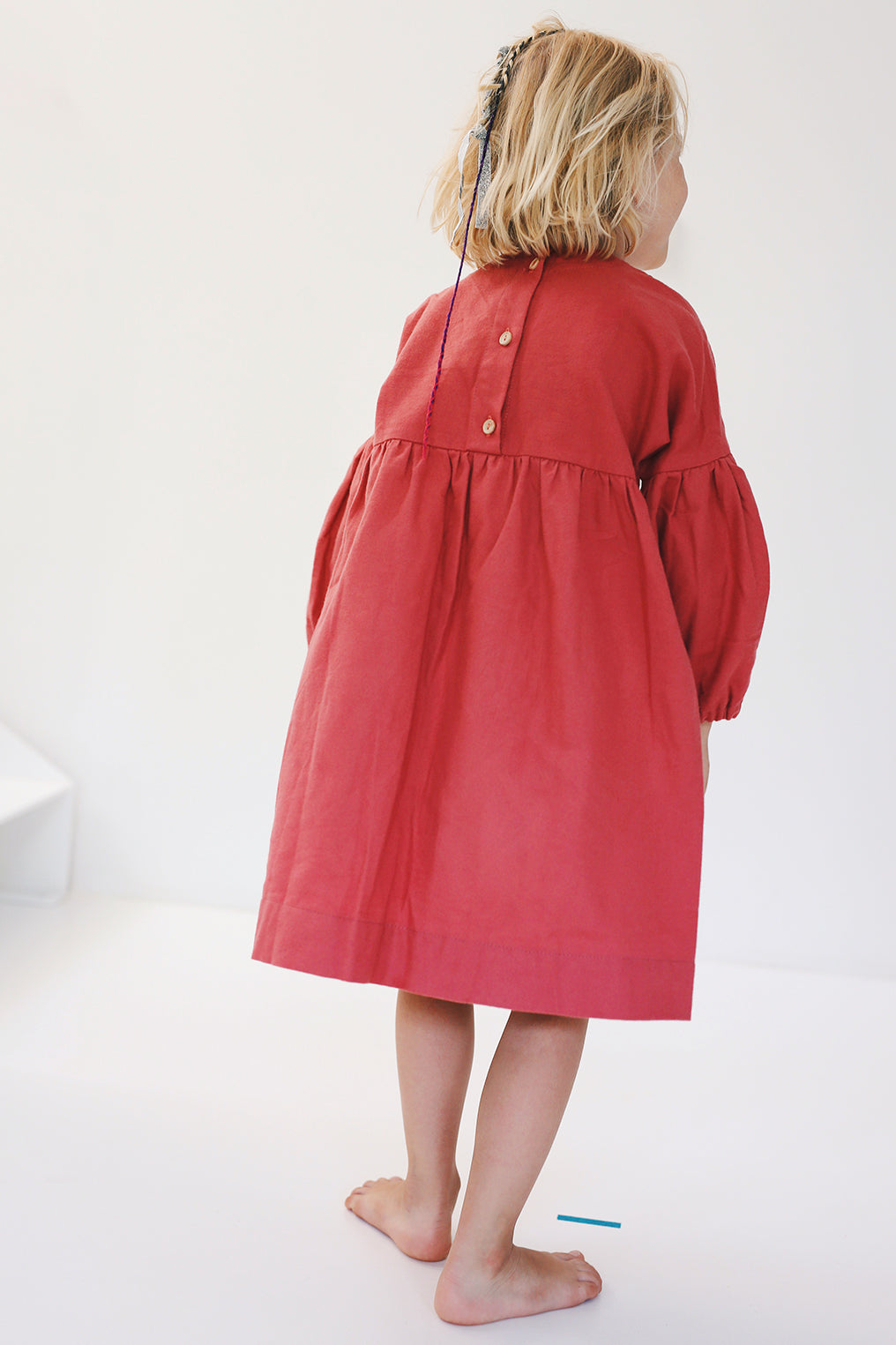 coral dress with long puffed sleeves