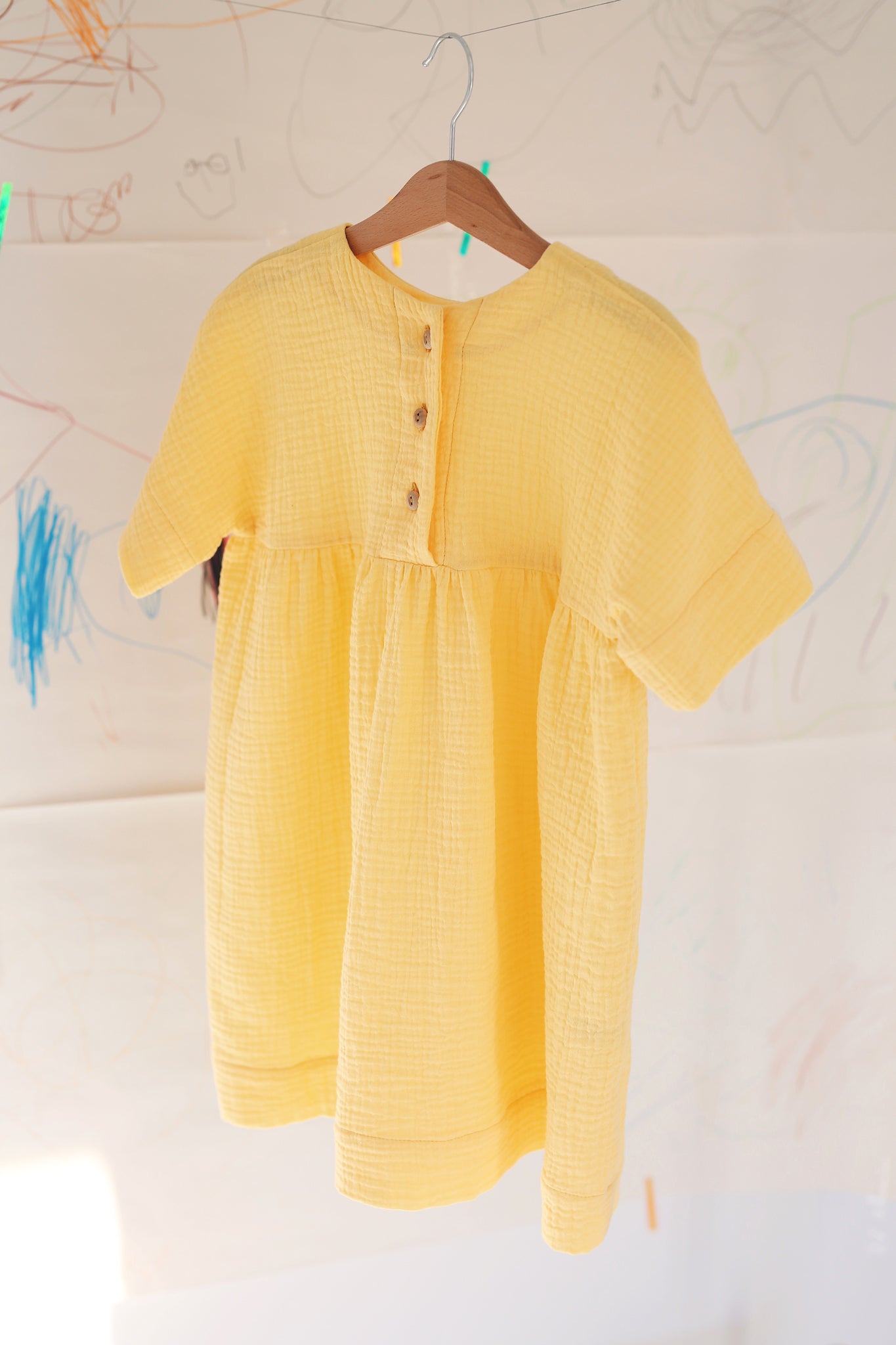 yellow dress with buttons on the back